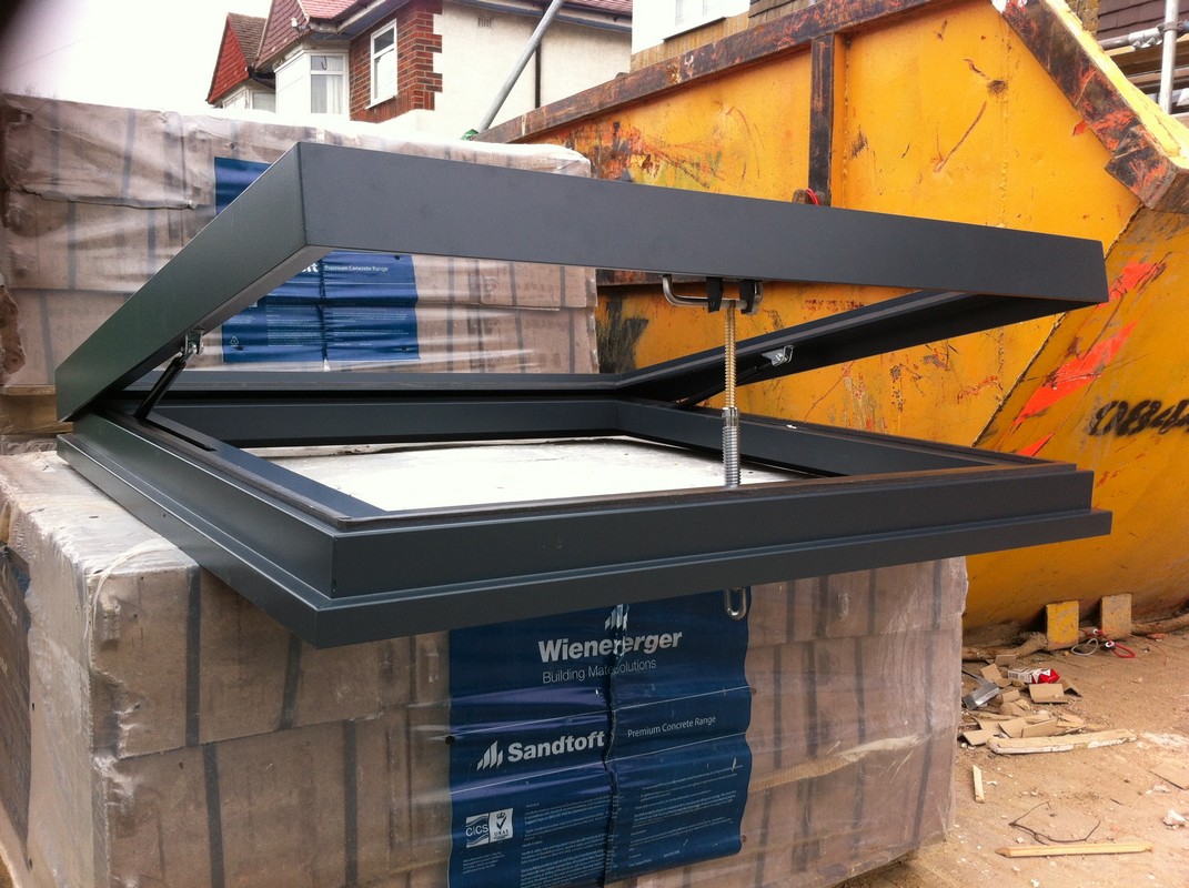 Opening flat roof skylight in anthracite grey installed in Thamesmead